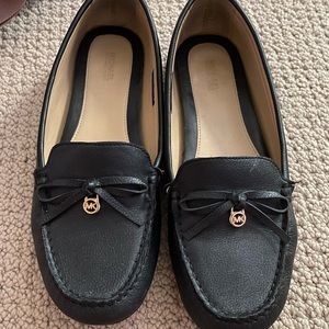 Black leather Michael Kors flats.